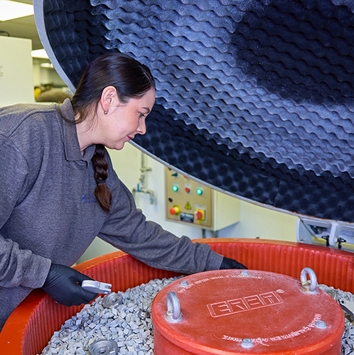 Vibro deburring (tumbling process) being checked by Samantha, 2025